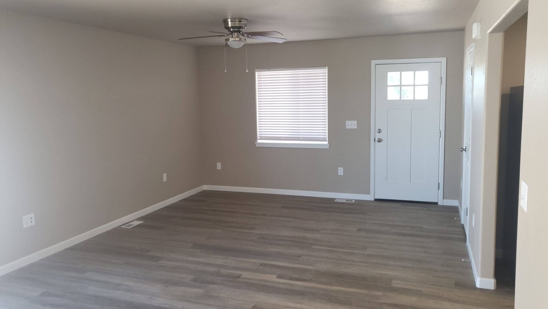 Empty room with wooden floor and window.