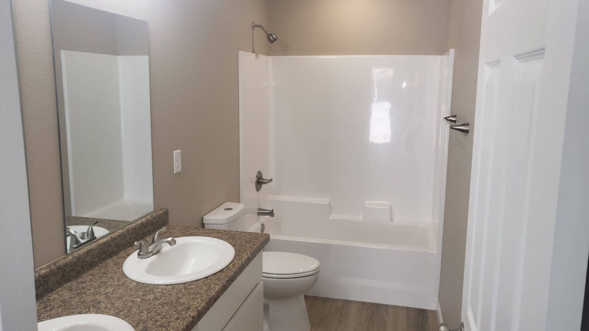 Modern bathroom with shower and vanity.