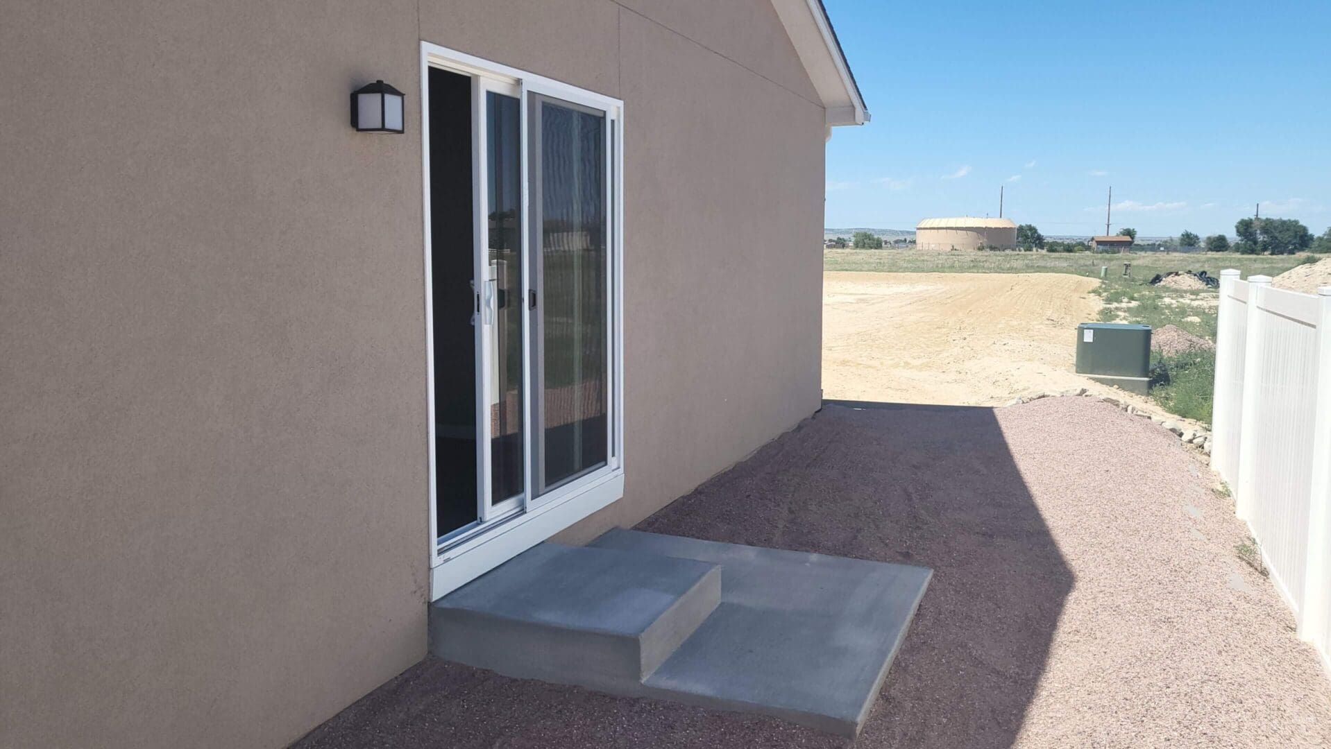 House exterior with sliding glass door.