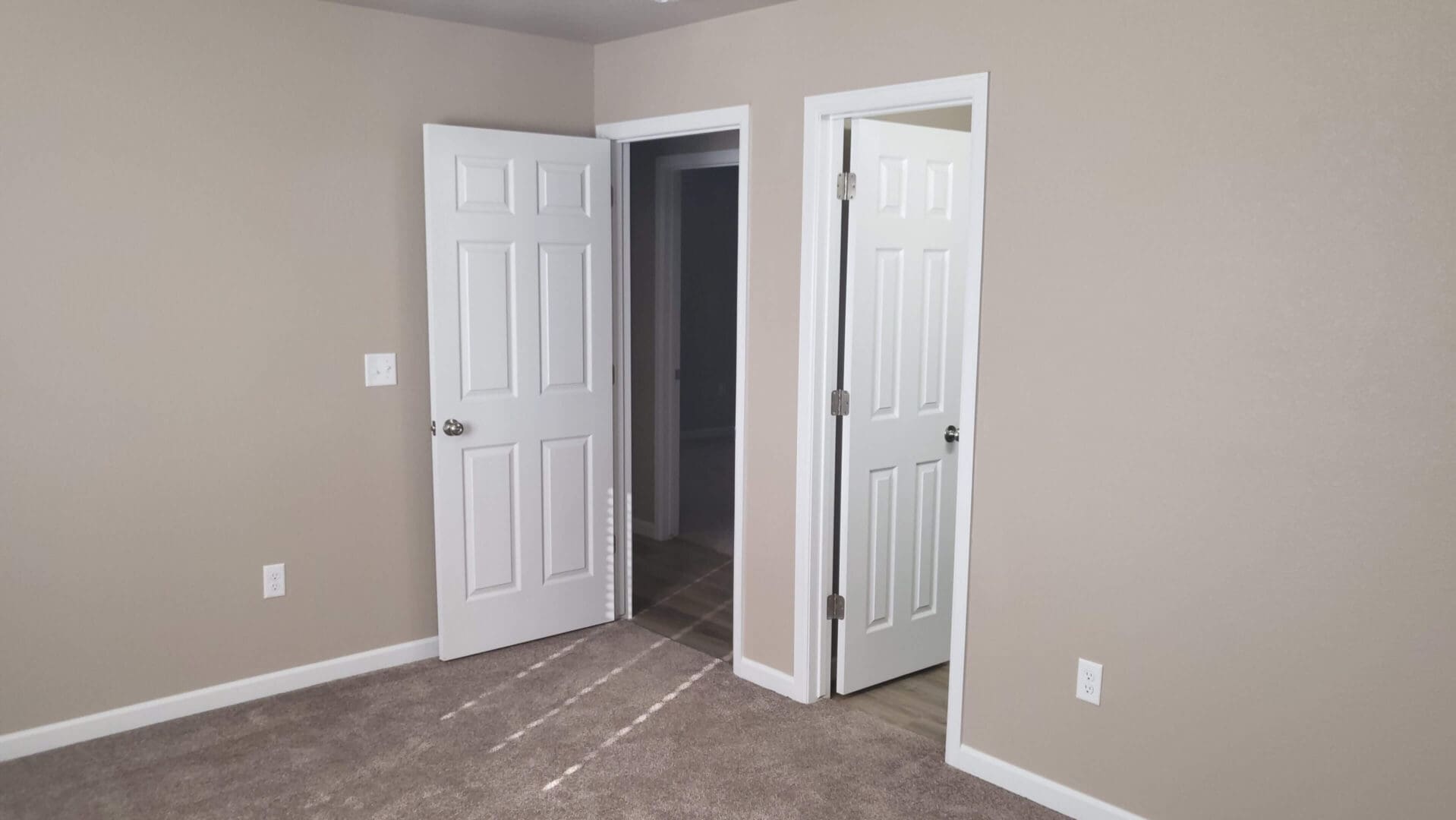 Room with two open white doors.