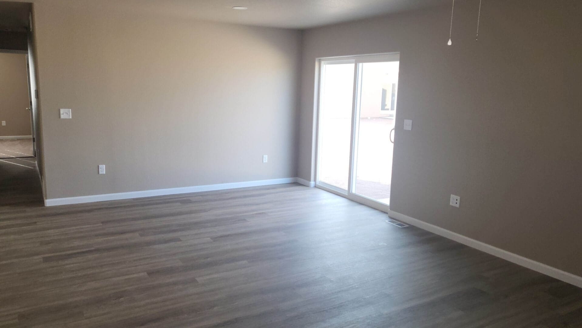 Empty room with wooden floor and window.