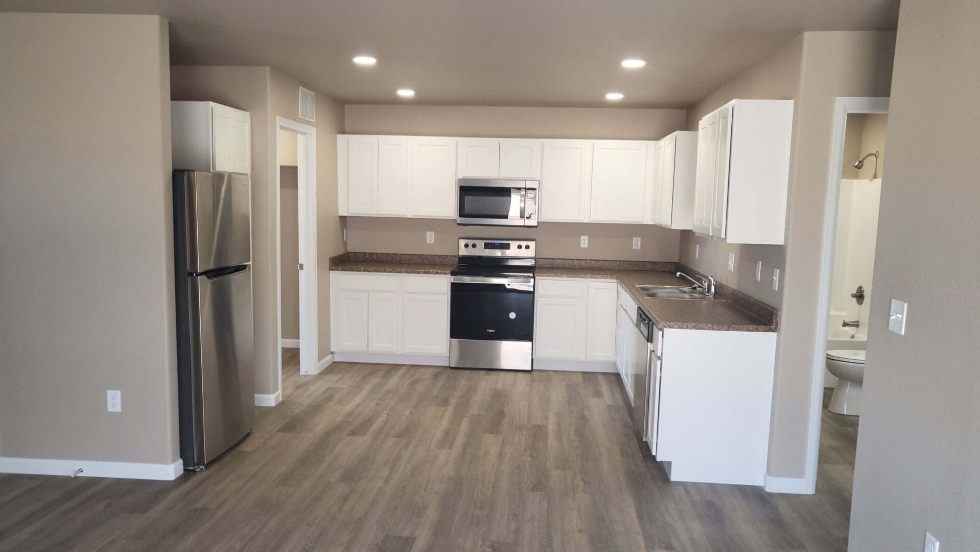 Modern kitchen with stainless steel appliances.