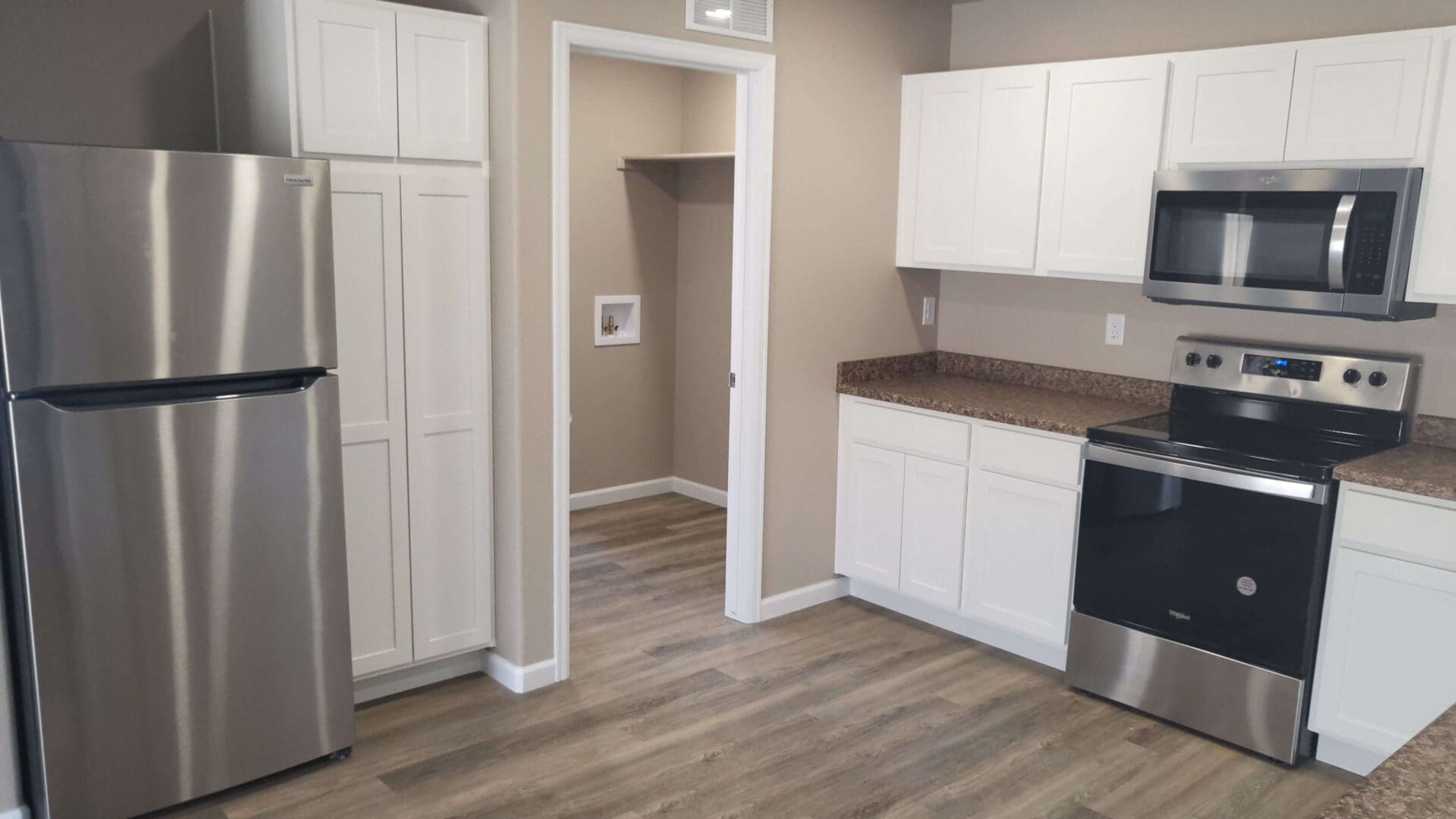 Modern kitchen with stainless steel appliances.